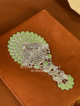 Rear side of the handcrafted silver mirror with detailed floral design