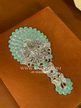 Close-up of the silver mirror showcasing intricate handcrafted detailing