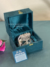 Pure silver cow and calf figurine displayed on a silver base