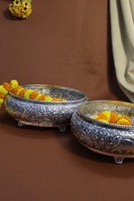 Handcrafted metal urli with detailed carvings and elephant patterns, symbolizing prosperity and harmony.