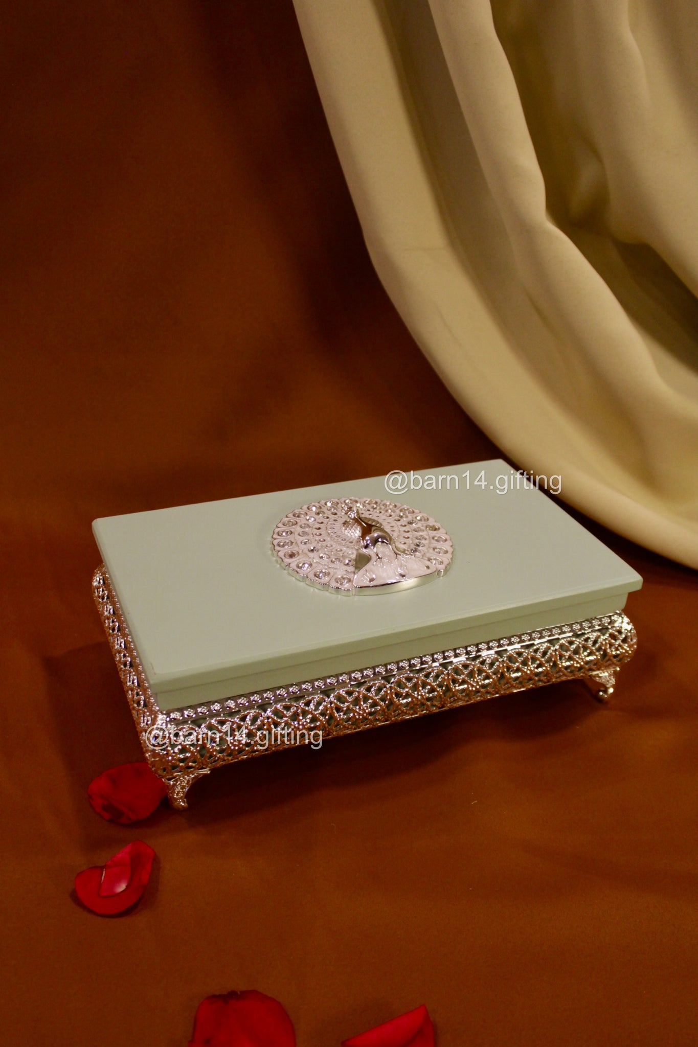Handcrafted enamel rectangle dry fruit box with peacock motif, stylish mewa box for Diwali, weddings, and corporate gifting.
