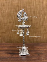 Silver finish five wick peacock diya stand with hanging bells, traditional lamp for Diwali, pooja, and festive rituals, symbol of prosperity and devotion.