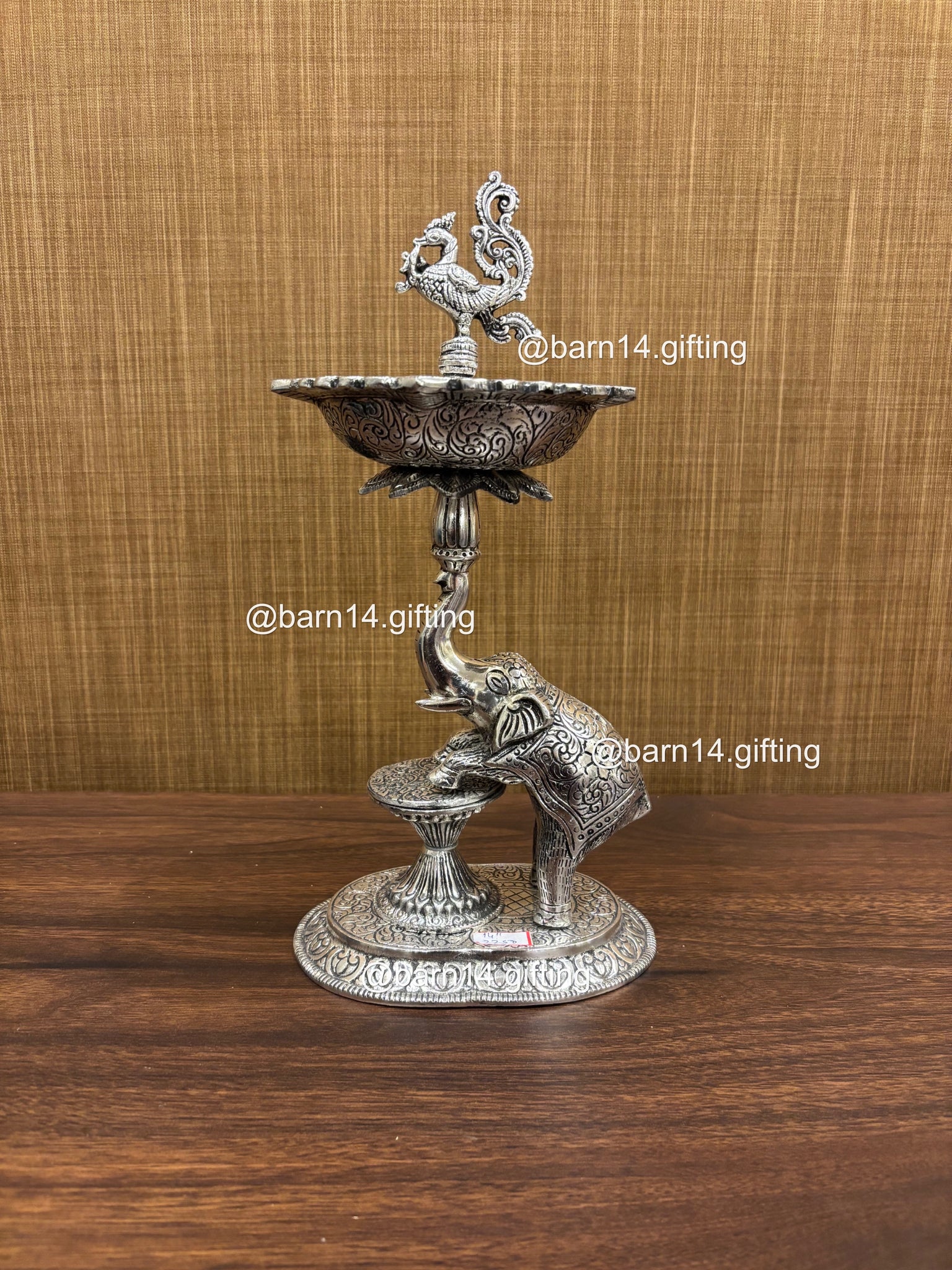 Silver finish Gaj Mayur diya stand with elephant base and peacock finial, traditional lamp for Diwali, housewarming, and daily pooja rituals.
