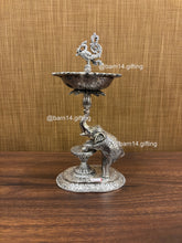 Silver finish Gaj Mayur diya stand with elephant base and peacock finial, traditional lamp for Diwali, housewarming, and daily pooja rituals.