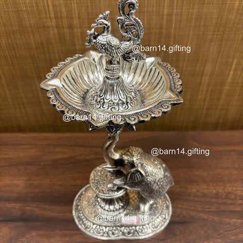 Silver finish Gaj Mayur diya stand with elephant base and peacock, traditional lamp for Diwali, housewarming, and daily pooja rituals.