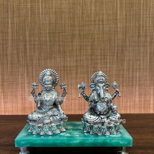 Beautifully handcrafted Ganesh and Lakshmi statue duo seated on a green base, representing divine blessings of wealth and knowledge — ideal for festive worship. auspicious gifting, Diwali gifting, housewarmings, and pooja décor.