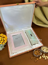 Elegant glitter-finish dry fruit box and photo frame gift set, perfect for Diwali, weddings, and festive gifting. Silver-plated detailing adds luxury and sparkle to celebrations