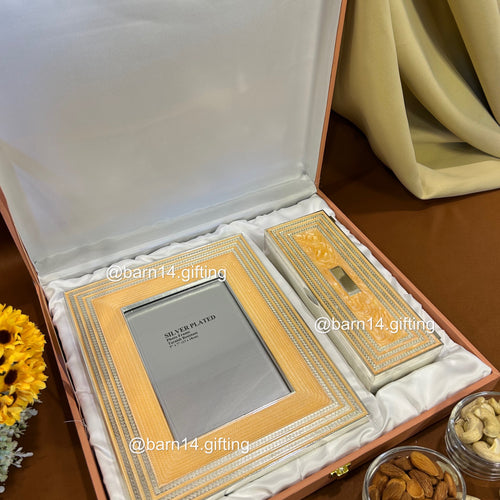 Elegant glitter-finish dry fruit box and photo frame gift set, perfect for Diwali, weddings, and festive gifting. Silver-plated detailing adds luxury and sparkle to celebrations