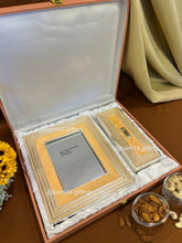 Elegant glitter-finish dry fruit box and photo frame gift set, perfect for Diwali, weddings, and festive gifting. Silver-plated detailing adds luxury and sparkle to celebrations