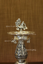 traditional diya stand with intricate peacock design and hanging ghungroos, elegant diya holder for temples, weddings, Diwali décor, and auspicious gifting.