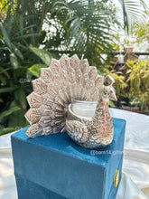 Elegant peacock design glass candle in silver finish – luxury gifting piece for Diwali, weddings, anniversaries, and corporate celebrations.