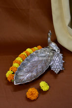Handcrafted peacock leaf tray with feather detailing, elegant silver centerpiece for weddings, housewarmings, and home décor.