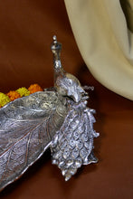 Handcrafted peacock leaf tray with feather detailing, elegant silver centerpiece for weddings, housewarmings, and home décor.