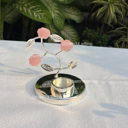 Silver-plated pink rose T-light holder with delicate stone flowers, elegant home décor and festive gifting choice for Diwali, weddings, and housewarmings.