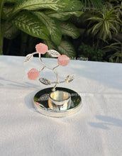 Silver-plated pink rose T-light holder with delicate stone flowers, elegant home décor and festive gifting choice for Diwali, weddings, and housewarmings.
