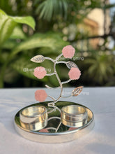 Silver-plated pink rose T-light holder with delicate stone flowers, elegant home décor and festive gifting choice for Diwali, weddings, and housewarmings.