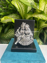 999 pure silver Radha Krishna idol on stand, handcrafted devotional gift symbolizing eternal love and harmony, ideal for weddings, anniversaries, and housewarmings.