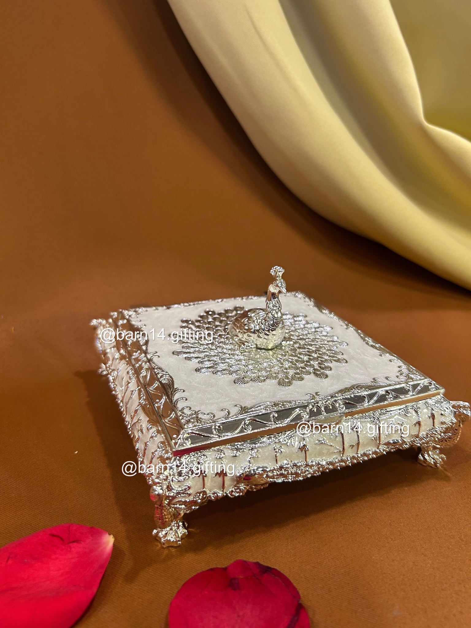 Premium enamel dry fruit box with ornate silver finish and peacock top, luxurious centerpiece and memorable gift for Diwali, weddings, anniversaries, and corporate celebrations.
