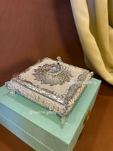 Premium enamel dry fruit box with ornate silver finish and peacock top, luxurious centerpiece and memorable gift for Diwali, weddings, anniversaries, and corporate celebrations.