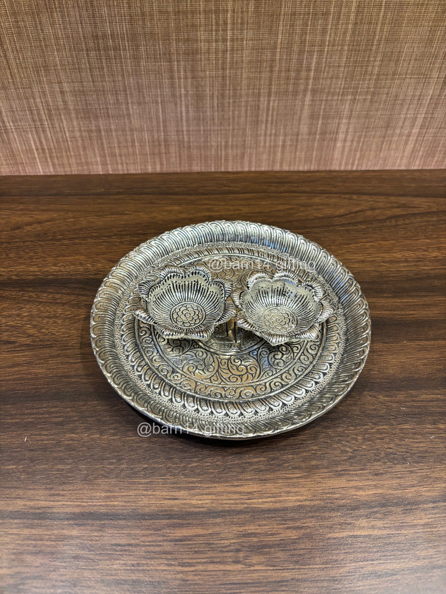 Traditional silver-finish aarti plate with decorative floral design bowls for roli, chawal, and kumkum during rituals.