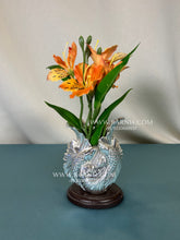 Pure Silver Fish Vase with fresh flowers on wooden base.